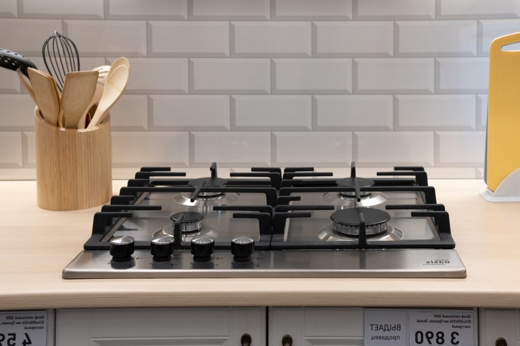 Modern hob gas stove countertop in big kitchen interior.